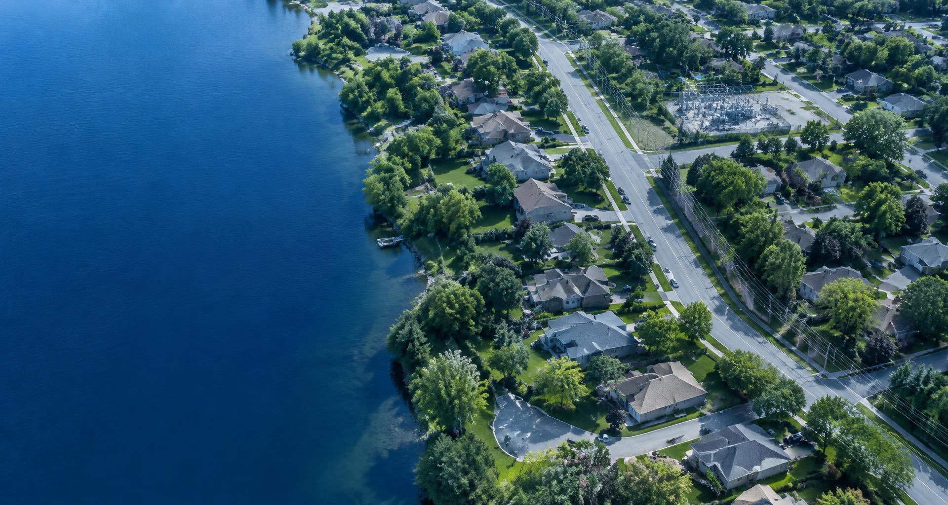 Aerial view of a utility service area with homes, roads, and water infrastructure